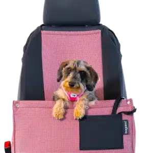 A small dog sits comfortably and safely in a dog car seat on the passenger seat of a car. The car seat is made with a soft yet durable material, providing a comfortable way for your dog to travel with you.